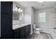 Bathroom with dark vanity, neutral countertop, and tiled shower and tub at 1112 Yeamans Hall Rd, Hanahan, SC 29410