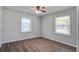 Bright bedroom featuring luxury vinyl plank flooring and two windows for natural light at 1112 Yeamans Hall Rd, Hanahan, SC 29410