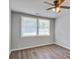 Well-lit bedroom with wood flooring, neutral walls, and large windows at 1112 Yeamans Hall Rd, Hanahan, SC 29410
