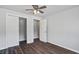 This bedroom boasts wood-look floors, a modern ceiling fan, and ample closet space at 1112 Yeamans Hall Rd, Hanahan, SC 29410