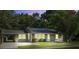 Charming single-story home with a well-manicured lawn, covered parking and mature trees at 1112 Yeamans Hall Rd, Hanahan, SC 29410