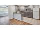 Open kitchen with gray cabinets, breakfast bar, stainless appliances, and tiled backsplash at 1112 Yeamans Hall Rd, Hanahan, SC 29410