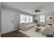 Bright living room with neutral furniture, ceiling fan, wood floors, and large windows at 1112 Yeamans Hall Rd, Hanahan, SC 29410
