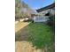 Spacious, landscaped backyard featuring garden beds, sitting area, and deck, ideal for outdoor activities at 112 Riviera Dr, Summerville, SC 29483