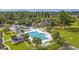 Stunning aerial view of the community pool, with palm trees and plenty of lounge chairs at 112 Riviera Dr, Summerville, SC 29483