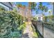 Fenced side yard with a stepping stone path leading to a shed and lush greenery, offering privacy and charm at 112 Riviera Dr, Summerville, SC 29483
