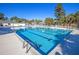 A beautifully maintained large outdoor swimming pool with ample seating and shaded pergola at 112 Riviera Dr, Summerville, SC 29483