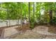 Backyard featuring a swing under a pergola, a stone patio, and a white fence at 114 Grand Palm Ln, Summerville, SC 29485