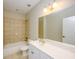 Well-lit bathroom with a tub and shower, toilet, and a large mirror over a white vanity at 114 Grand Palm Ln, Summerville, SC 29485