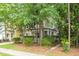 Charming two-story townhouse with a covered front porch, complemented by lush landscaping at 114 Grand Palm Ln, Summerville, SC 29485