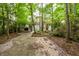 Exterior view of the home with a brick driveway, surrounded by mature trees and landscaping at 114 Grand Palm Ln, Summerville, SC 29485