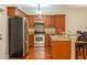 Bright kitchen featuring stainless steel appliances, wood cabinetry, granite countertops, and wood floors at 114 Grand Palm Ln, Summerville, SC 29485