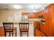 A well-lit kitchen with wooden cabinets, stainless steel appliances, and a granite-topped island with seating at 114 Grand Palm Ln, Summerville, SC 29485
