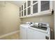 Functional laundry room with a modern washer and dryer set and built-in upper cabinets at 114 Grand Palm Ln, Summerville, SC 29485