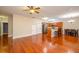 Spacious open-concept living area seamlessly integrating kitchen and dining spaces with gleaming wood floors at 114 Grand Palm Ln, Summerville, SC 29485