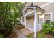 Inviting covered porch features classic white columns and lattice details at 114 Grand Palm Ln, Summerville, SC 29485