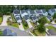 Aerial view of a neighborhood with modern homes, lush landscaping, and tree-lined streets at 120 E Respite Ln, Summerville, SC 29483