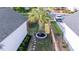 Aerial view of the backyard showing the fence line, palm tree, mulch bed, and stepping stone pathway at 120 E Respite Ln, Summerville, SC 29483