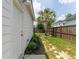 Side yard featuring fresh mulch, a palm tree, and a stepping stone path leading to the back fence at 120 E Respite Ln, Summerville, SC 29483