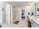 Bright bathroom featuring dual sink vanity, tile floors, and glass door walk-in shower at 120 E Respite Ln, Summerville, SC 29483