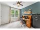 Office features a ceiling fan, window views, wood desk, and a dark accent wall at 120 E Respite Ln, Summerville, SC 29483
