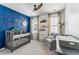 This charming Bedroom features a blue accent wall, cute decor, and a comfortable armchair at 120 E Respite Ln, Summerville, SC 29483