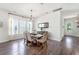 Bright dining room with hardwood floors, modern chandelier, and large windows at 120 E Respite Ln, Summerville, SC 29483