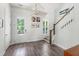 Bright foyer featuring hardwood floors, staircase, modern lighting, and access to the outside at 120 E Respite Ln, Summerville, SC 29483