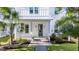 Inviting front entrance with a quaint porch, palm tree, and manicured garden at 120 E Respite Ln, Summerville, SC 29483