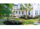 Charming two-story home with lush landscaping, vibrant flowers, and a welcoming front porch at 120 E Respite Ln, Summerville, SC 29483