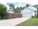 View of a well-maintained white house featuring a long driveway and attached two-car garage at 120 E Respite Ln, Summerville, SC 29483