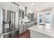 Modern kitchen features stainless appliances, gray cabinetry, and large quartz countertop island at 120 E Respite Ln, Summerville, SC 29483