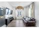 Comfortable living room with leather sofa, large windows, and stylish decor at 120 E Respite Ln, Summerville, SC 29483