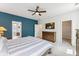 Bright bedroom features a blue accent wall, a ceiling fan and bathroom entrance at 120 E Respite Ln, Summerville, SC 29483