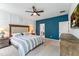 Bright bedroom features a blue accent wall, a ceiling fan and walk in to bathroom at 120 E Respite Ln, Summerville, SC 29483