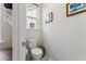 Bright powder room with a modern toilet, neutral paint, and decorative artwork at 120 E Respite Ln, Summerville, SC 29483