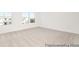 An empty carpeted bedroom with two windows at 1219 Homecoming Blvd # Cc1-27, Ravenel, SC 29470