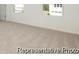 An empty carpeted bedroom with two windows at 1219 Homecoming Blvd # Cc1-27, Ravenel, SC 29470