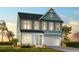 Charming two-story home featuring a blue exterior, a well-manicured lawn, and an attached two-car garage at 1219 Homecoming Blvd # Cc1-27, Ravenel, SC 29470