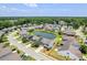 Aerial view of a neighborhood with tree-lined streets and houses surrounding a central pond at 1302 Paint Horse Ct, Mount Pleasant, SC 29429