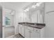 Bathroom featuring granite counters, double sink vanity and linen closet at 1302 Paint Horse Ct, Mount Pleasant, SC 29429