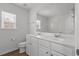 Bright bathroom with a dual sink vanity, large mirror, and wood look flooring at 1302 Paint Horse Ct, Mount Pleasant, SC 29429