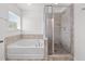 Bright bathroom with soaking tub, tiled shower, and window at 1302 Paint Horse Ct, Mount Pleasant, SC 29429