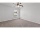 This bedroom features neutral carpeting, a ceiling fan, and a window for natural light at 1302 Paint Horse Ct, Mount Pleasant, SC 29429