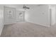 Bright bedroom with neutral carpet, ceiling fan, and two windows offering natural light at 1302 Paint Horse Ct, Mount Pleasant, SC 29429