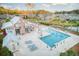 Beautiful zero-entry community pool with lounge chairs, tables, palm trees, and a covered patio area at 1302 Paint Horse Ct, Mount Pleasant, SC 29429
