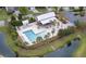 A beautiful zero-entry community pool features a covered patio, lounge chairs, and is surrounded by lush landscaping at 1302 Paint Horse Ct, Mount Pleasant, SC 29429
