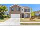 Charming two-story brick home featuring a two-car garage and a well-manicured front yard at 1302 Paint Horse Ct, Mount Pleasant, SC 29429