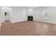 Bright living room featuring neutral paint, fireplace, large windows, and stylish wood-look floors at 1302 Paint Horse Ct, Mount Pleasant, SC 29429