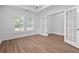 Bright room with wood floors, white walls, windows with shutters, and french doors at 1302 Paint Horse Ct, Mount Pleasant, SC 29429